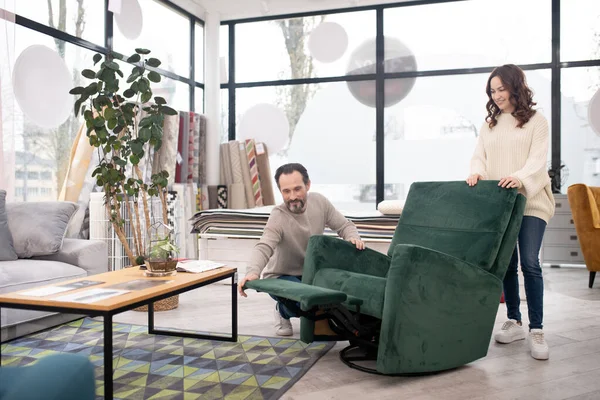 Hombre y mujer en suéteres ligeros pasando tiempo en una tienda de muebles —  Fotos de Stock