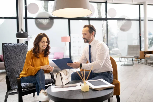 Möbeldesigner i slips och vit skjorta pratar med kunden — Stockfoto