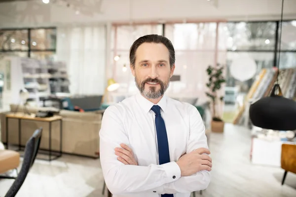 Furniture designer in tie and white shirt looking positive