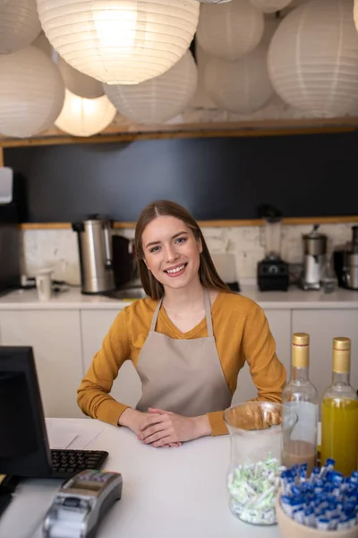 Charming and smiling barista standing at the counter — 스톡 사진