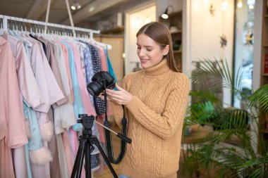 Female photographer using a tripod for photo shooting