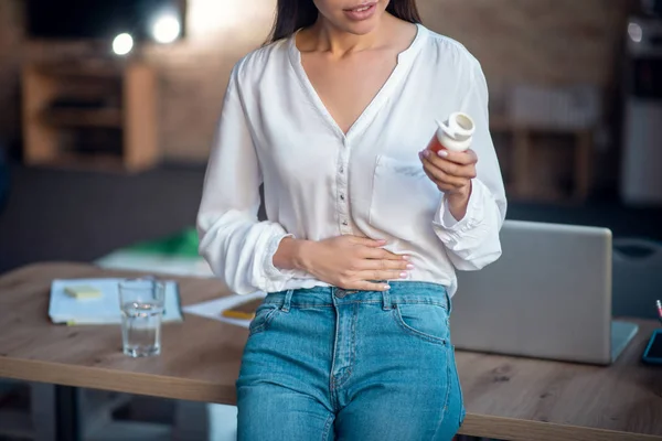Pleasant young woman putting hand on her stomach — Stock Photo, Image