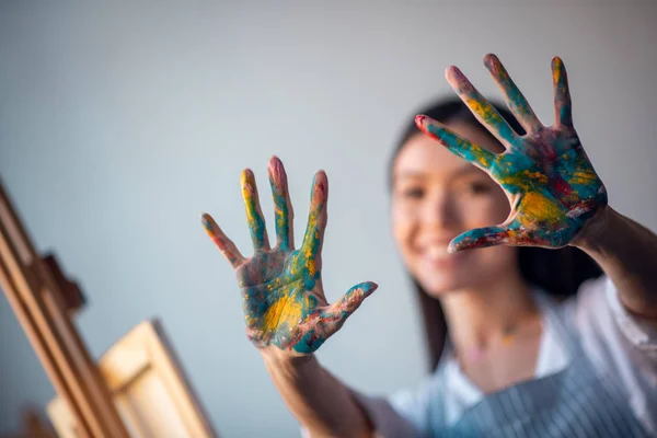 Selective focus of hands in paint being shown to you — 스톡 사진