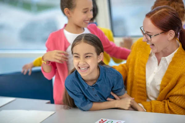 Laughing teacher having fun with her schoolgirl — 스톡 사진