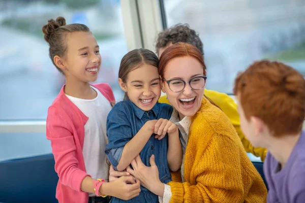 Smiling teacher playing active games with her pupils — Stock Photo, Image