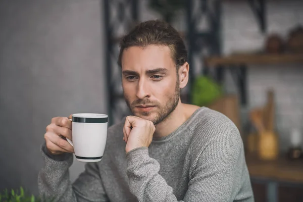 Young bearded handsome man in grey looking disturbed — 스톡 사진