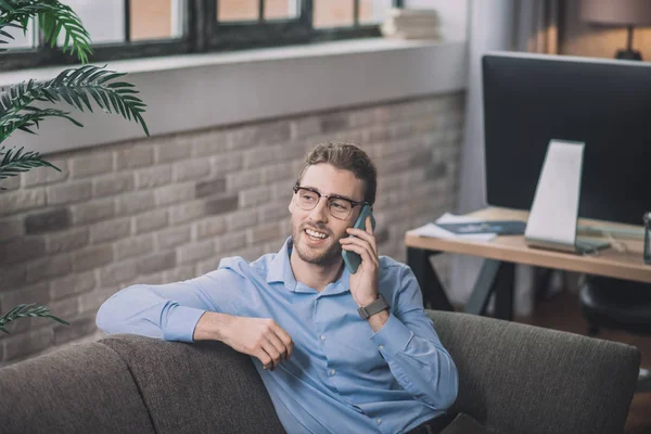 stock image Young bearded man in blue shirt feeling good