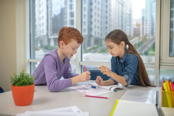 Two classmates working on their writing task — Stock Photo, Image