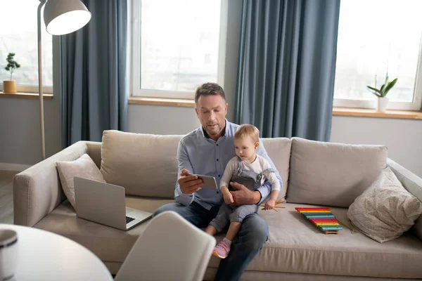 Mature father and his little daughter watching a movie together — 스톡 사진