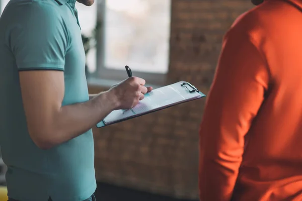 Nice pleasant man holding a pen in his hands — 스톡 사진