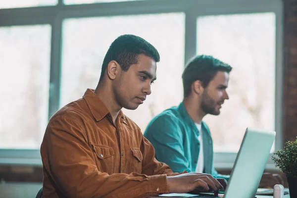 Jovem inteligente se concentrando em seu trabalho — Fotografia de Stock