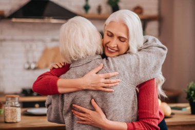 Two mature grey-haired positive ladies feeling wonderful