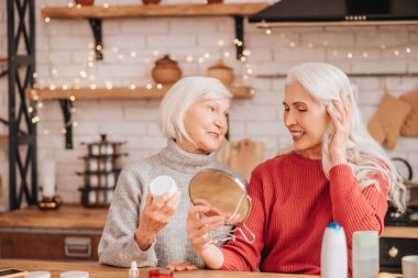 Two good-looking elderly women having good time