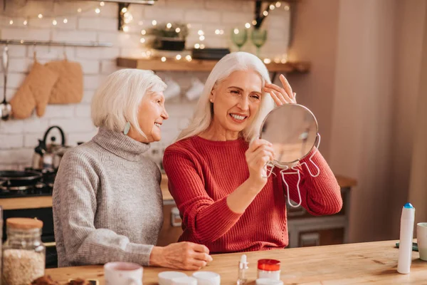 Two good-looking elderly women looking happy and joyful
