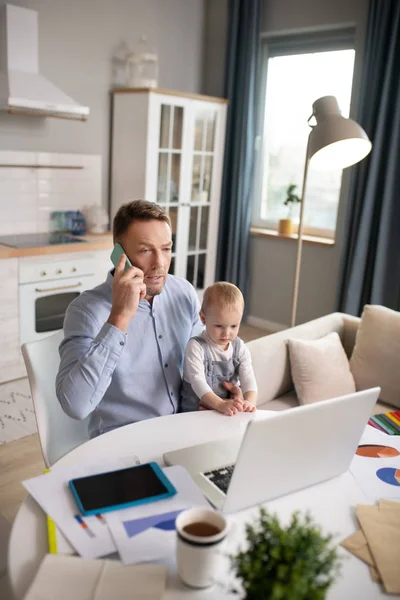Volwassen vader zitten met zijn dochter en het hebben van een telefoontje — Stockfoto