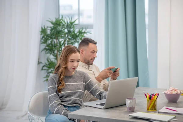 Chica de pelo largo en camisa gris y su padre pasar tiempo en casa — Foto de Stock