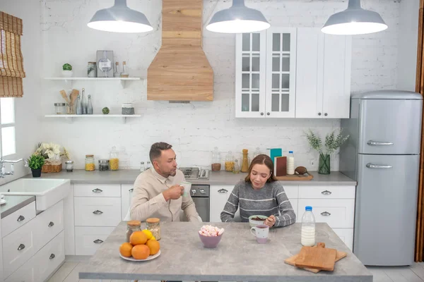 Lycklig far och dotter pratar under frukosten. — Stockfoto