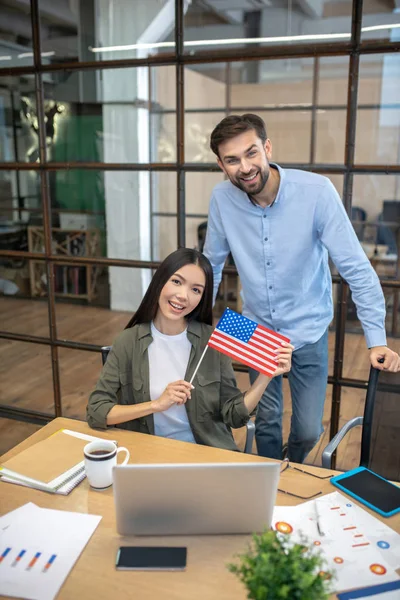 Two employees feeling good in the office of american company