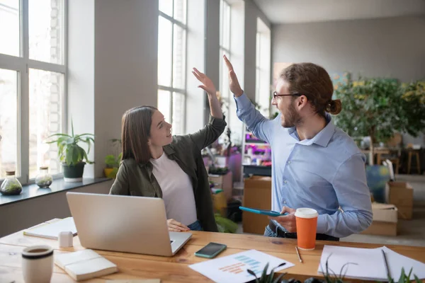 Man en meisje die elkaar aankijken en hun handen opsteken. — Stockfoto