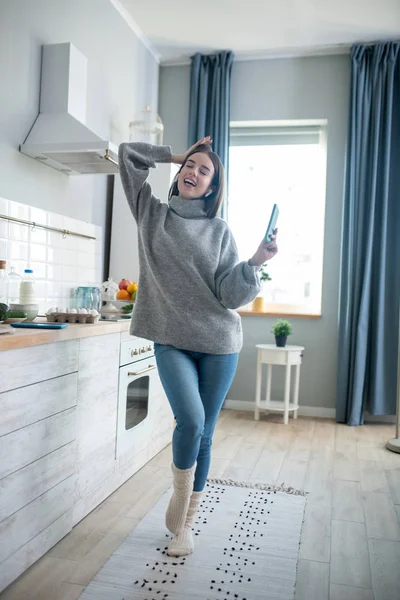 Dark-haired girl in a grey sweater feeling amazing — Stok fotoğraf