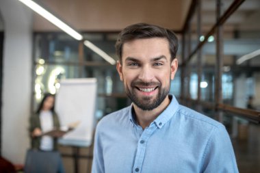 Handsome bearded man smiling and looking contented