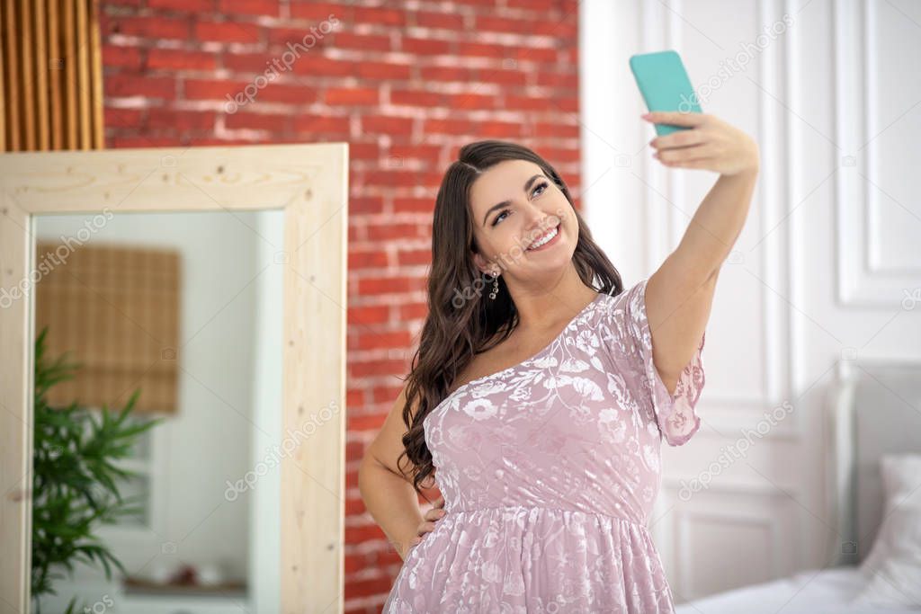 Young plus-size woman making selfie and looking amazing