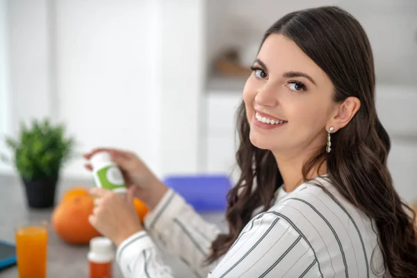 Mujer guapa de pelo largo con una blusa a rayas que parece feliz — Foto de Stock