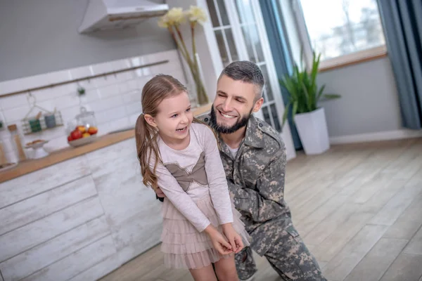 Dad in uniform is having fun playing with his little daughter. — 스톡 사진