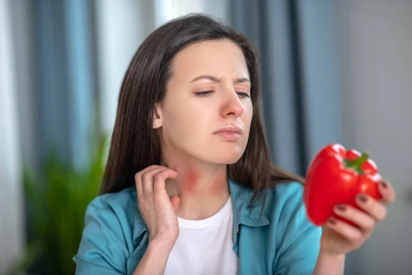 Woman having an allergy for a sweet pepper — Stok fotoğraf