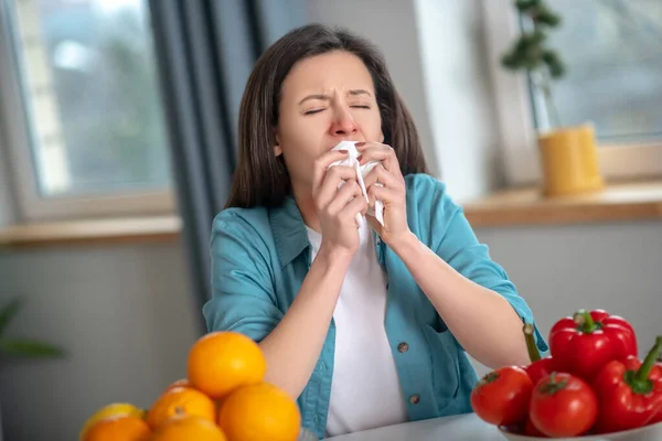 Woman having runny nose and sneezing because of allergy — Stok fotoğraf