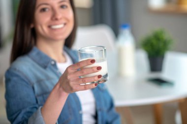 Woman holding a glass of tasty milk