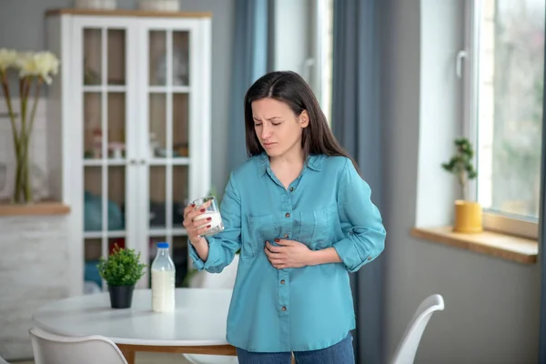 Woman having a metabolic disorder because of dairy products — Stok fotoğraf