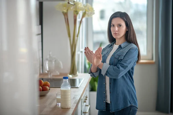 Young woman refusing to drink dairy products — Stockfoto