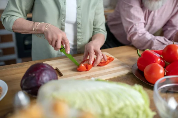 Mujer cocinando tomates para una comida vegetariana — Foto de Stock
