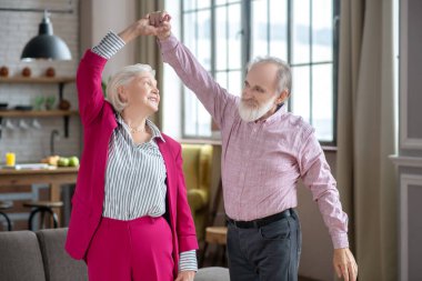 Happy elderly couple dancing and enjoying their day