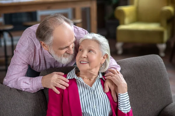 Elderly grey-haired couple looking at each other — Stock Fotó