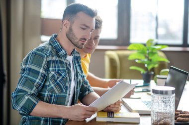 Two young men working remotely from home