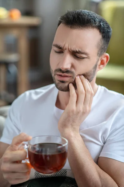 Dark-haired young man suffering from the toothache — Stockfoto