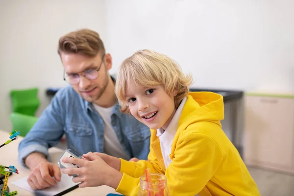 Blonder Junge mit Steuergerät, der aufgeregt lächelt — Stockfoto