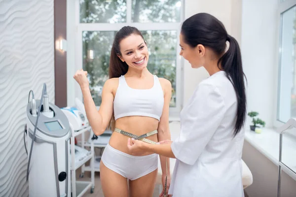 Mujer sintiéndose satisfecha después de perder peso llegando a especialista en dieta — Foto de Stock