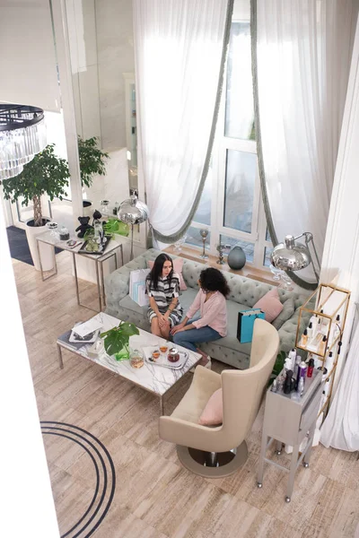 Top view picture of a beautiful room and two women sitting on the sofa — 스톡 사진
