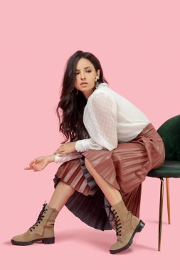 Beyaz bluzlu güzel esmer kadın endişeli görünüyor.