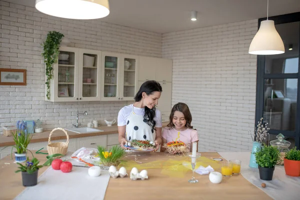 Mom and daughter looking busy in the kitchen