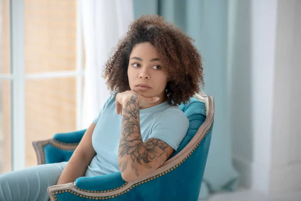 Young woman bored at home in an armchair. — Stock Photo, Image