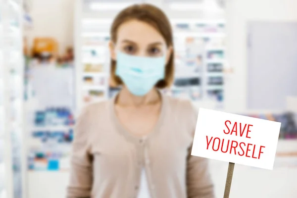 Young woman wearing mask and looking serious — Stock Photo, Image