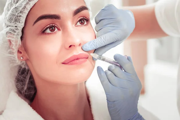 Client having injection into upper lip enjoying beauty treatment — Stock Photo, Image