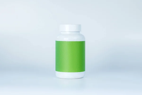 A bottle of supplements with green label — Stock Photo, Image