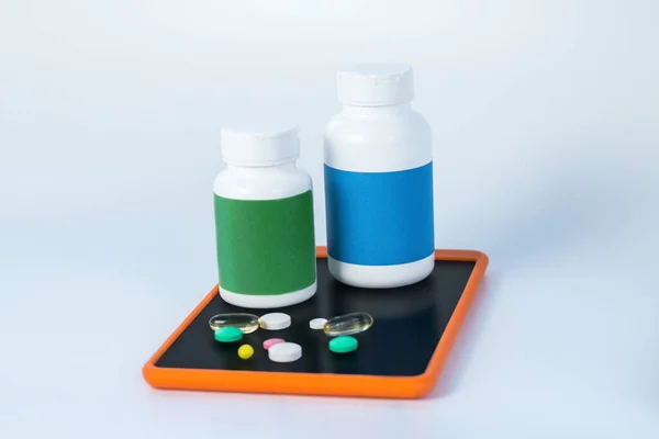 Two different bottles of vitamins on the smartphone — Stock Photo, Image