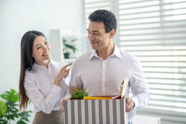 Sorridente donna dai capelli scuri toccare spalla del suo collega — Foto Stock