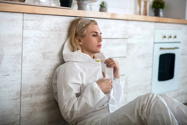 Blond vrouw in witte werkkleding zich slecht voelen — Stockfoto